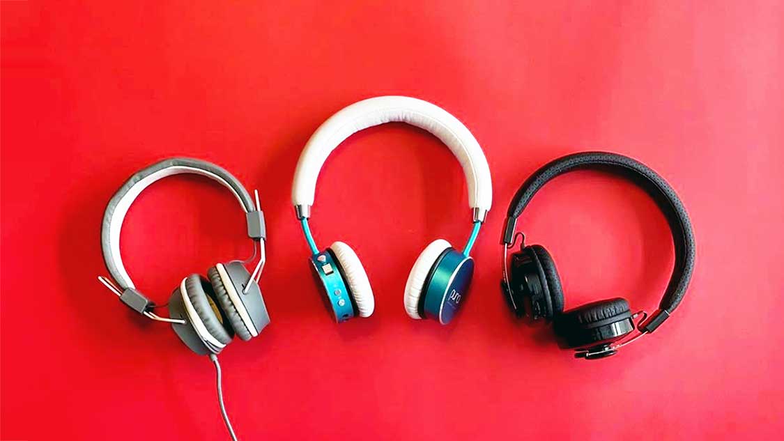 three sets of headphones for kids displayed against a red background