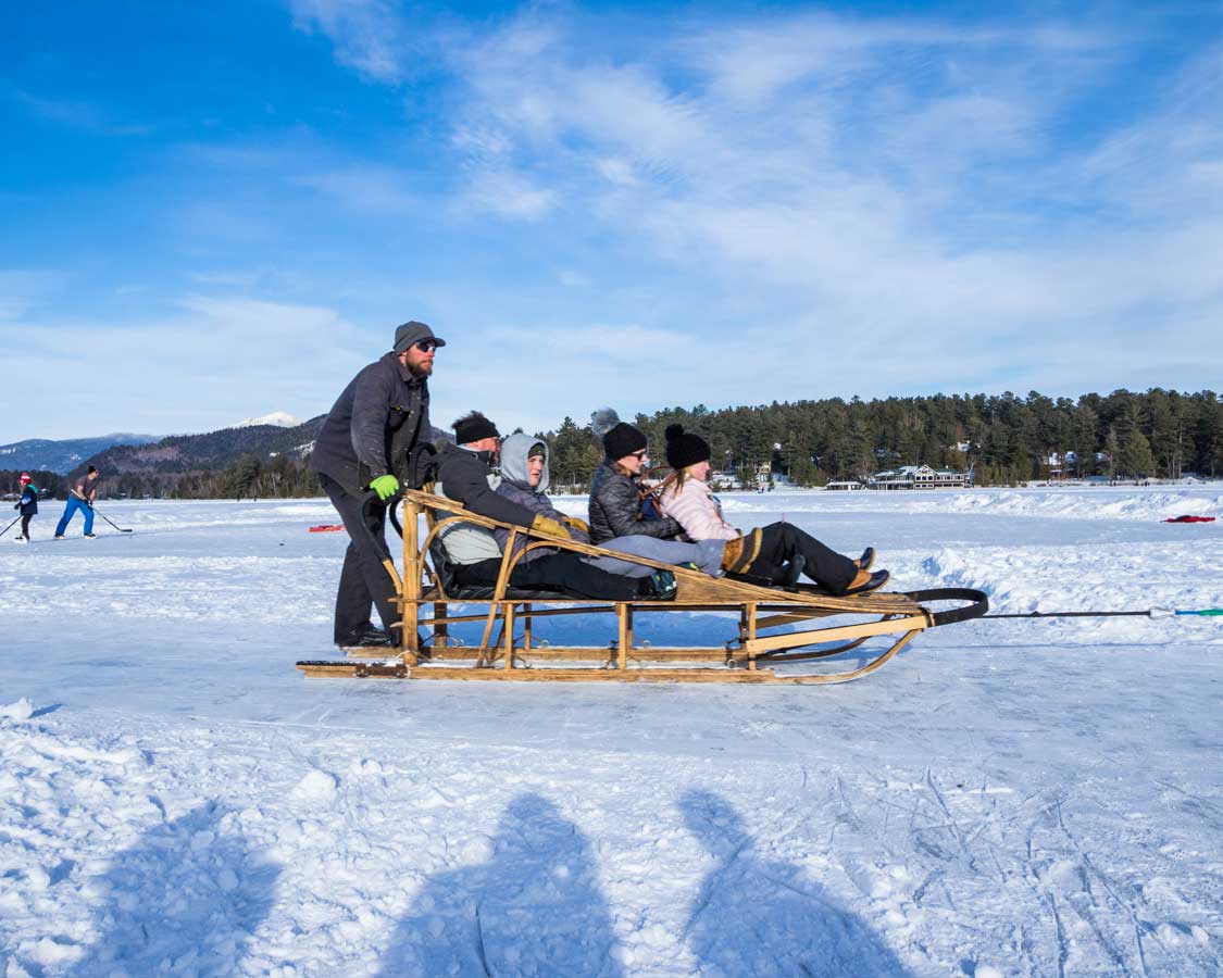 Mirror lake dogsledding in Lake Placid during winter