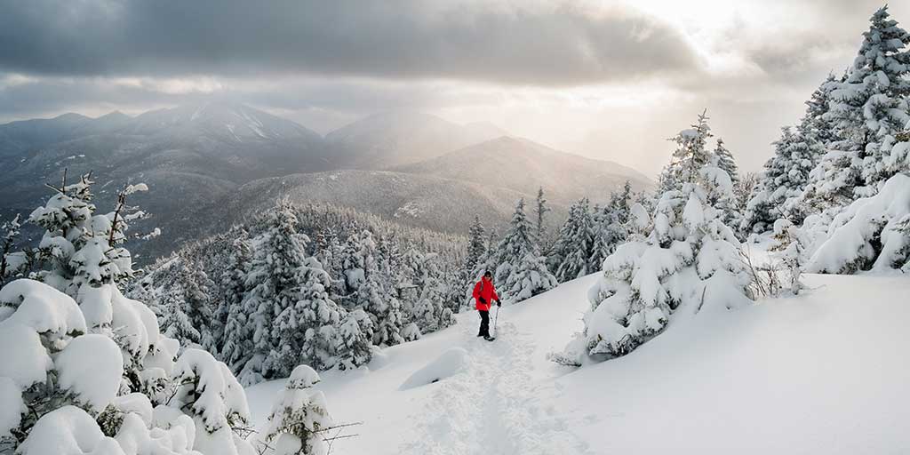 Snowshoer high in the Adirondack Mountains near Lake Placid in winter