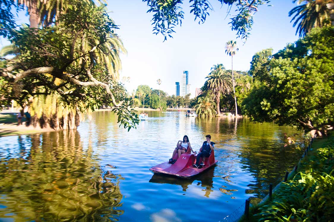 A young couple rides a paddle boat in a Palermo Buenos Aires park