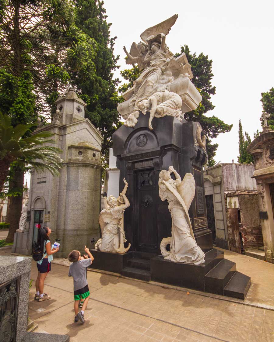 A mother and son wander around Recoleta Cemetery in Buenos Aires for children