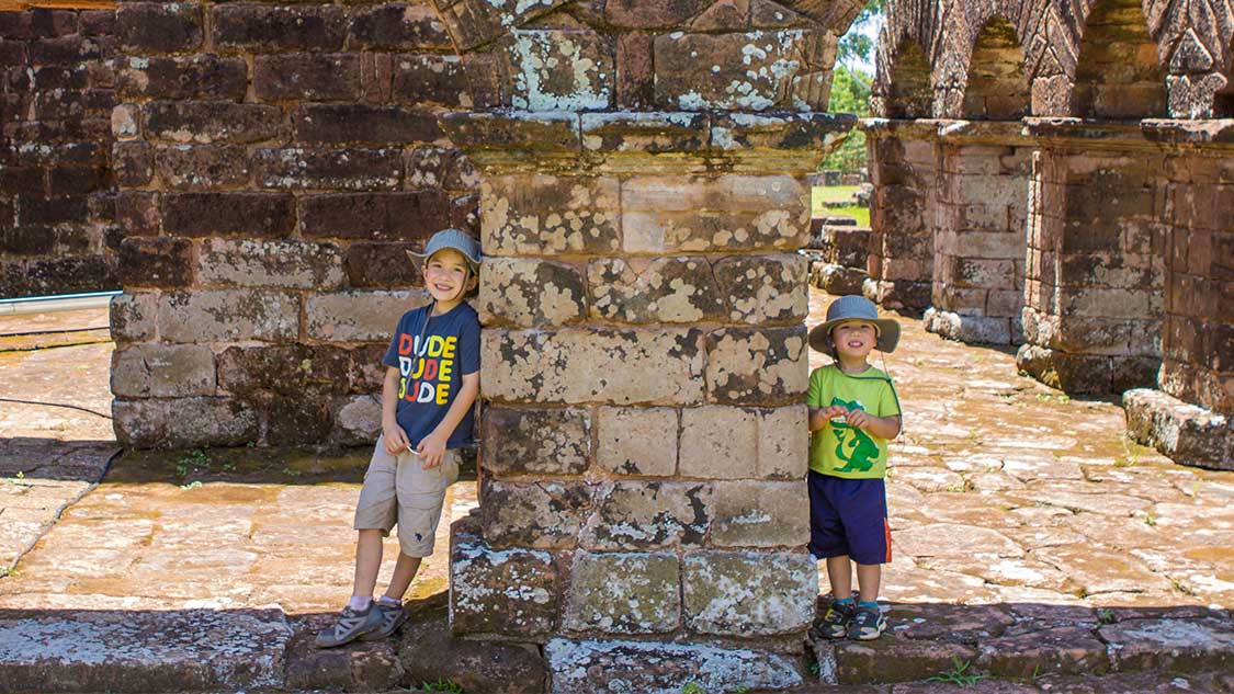 Two boys explore Jesuit ruins in Paraguay