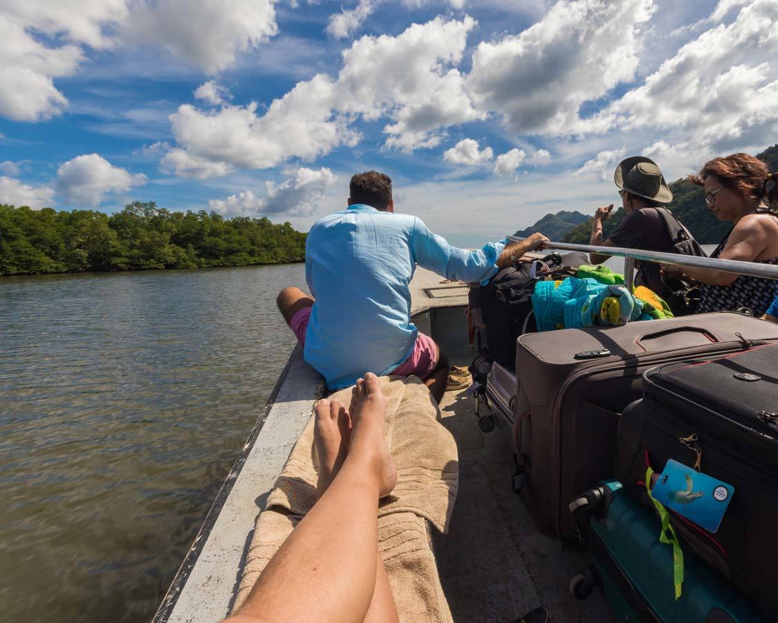 Man sitting on a boat traveling with suitcases