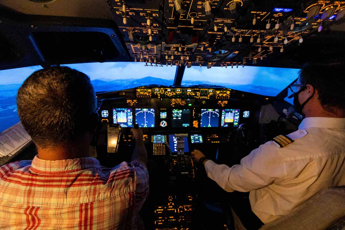 Pilots fly a flight simulator at Aerosim Laval