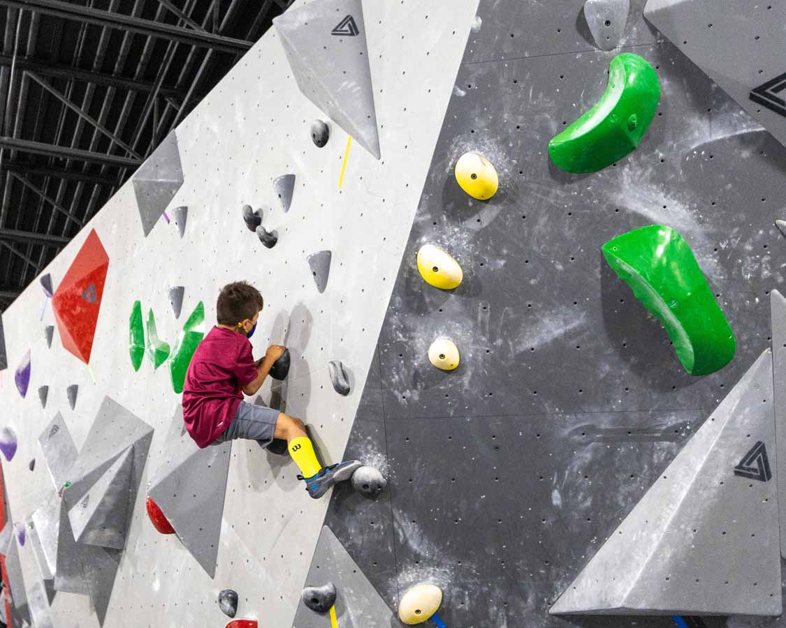 Child bouldering at La Crux Laval climbing gym