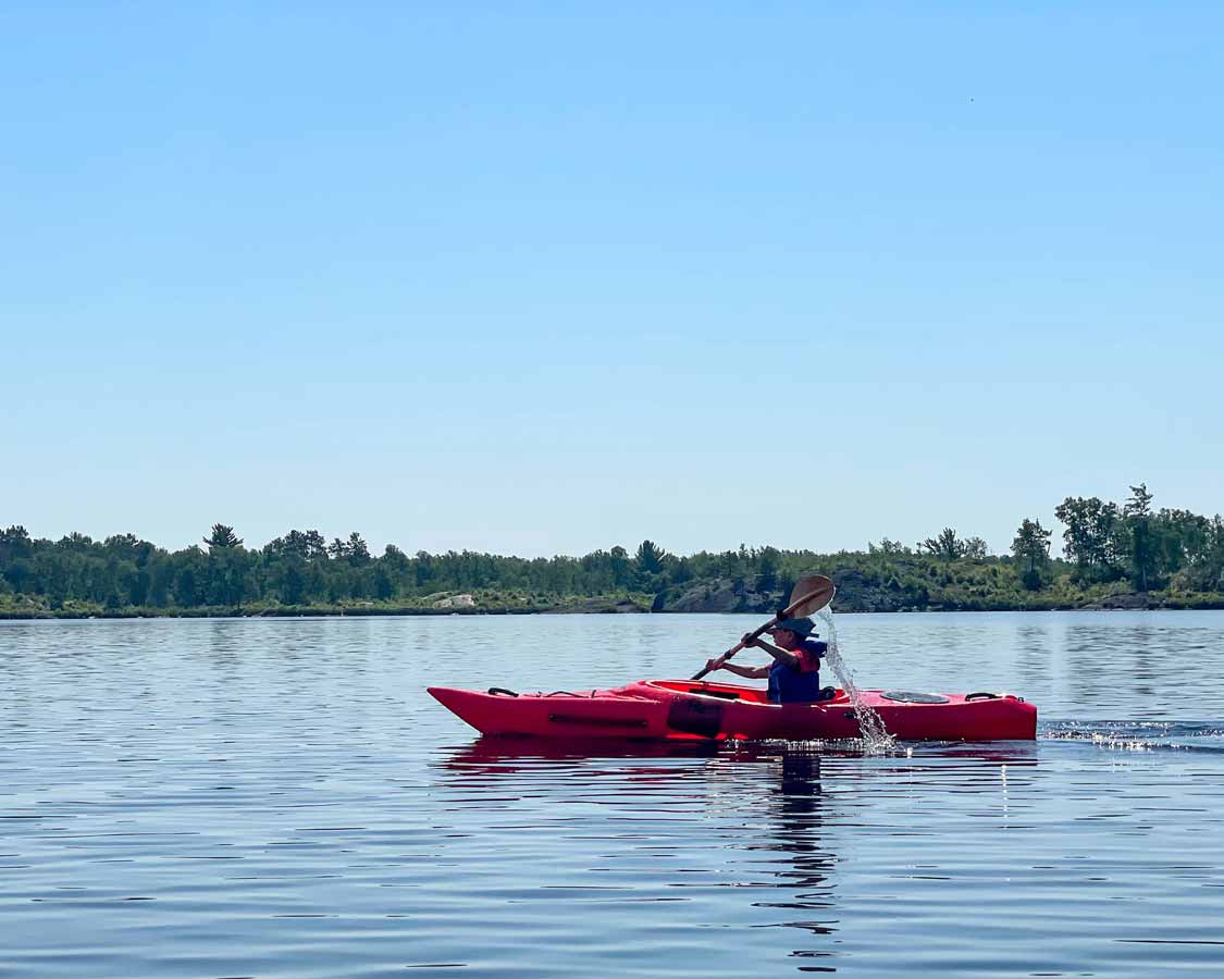 young boy kayaking at Windy Lake Provincial Park