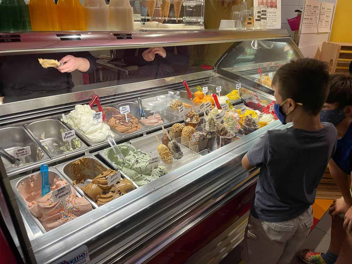 A boy chooses ice cream flavors at La Creme Folle