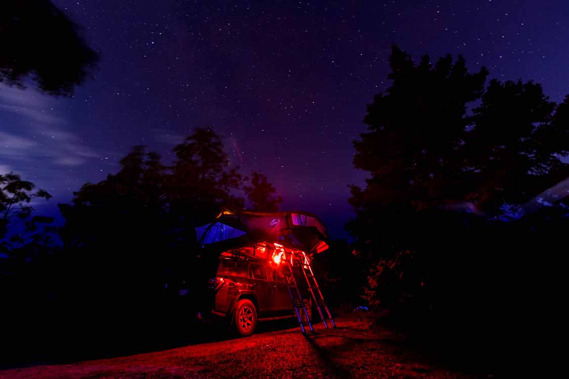 Overland truck with rooftop tent camping at Rainbow Falls Provincial Park