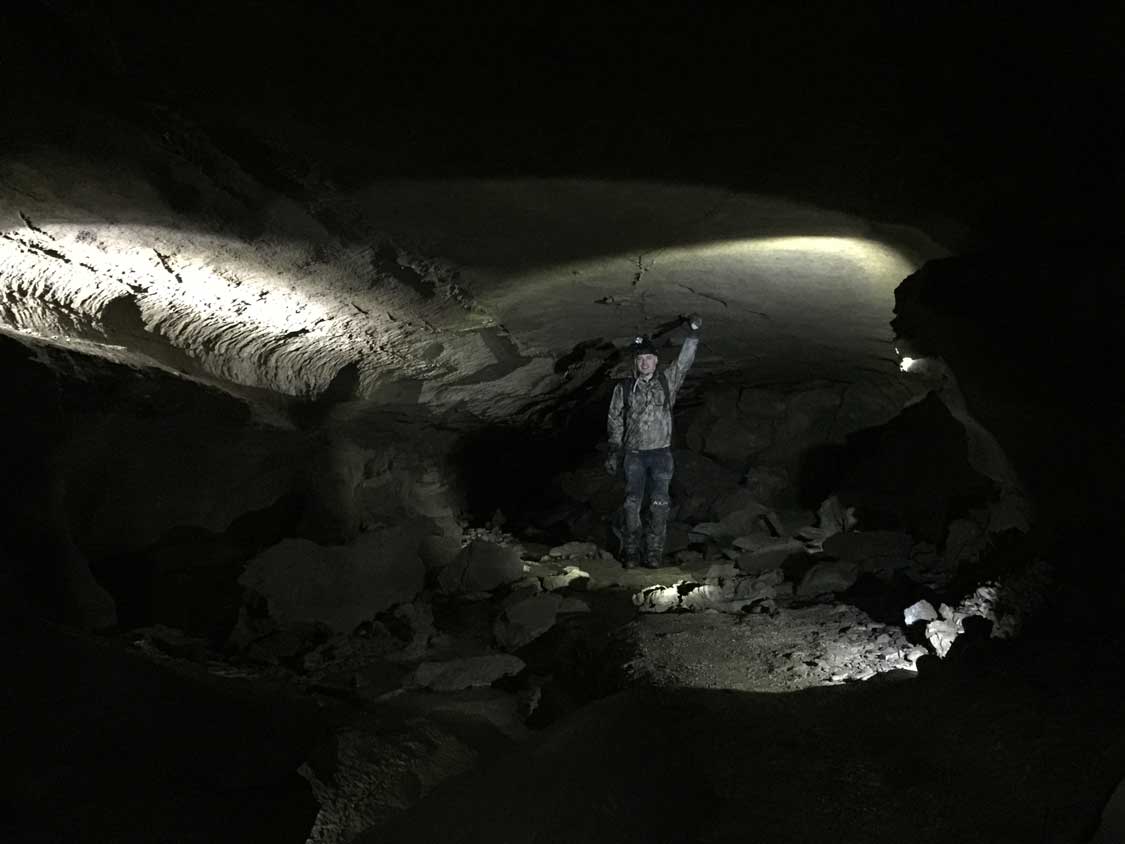 Man standing among lights in Clarksville Caves in New York
