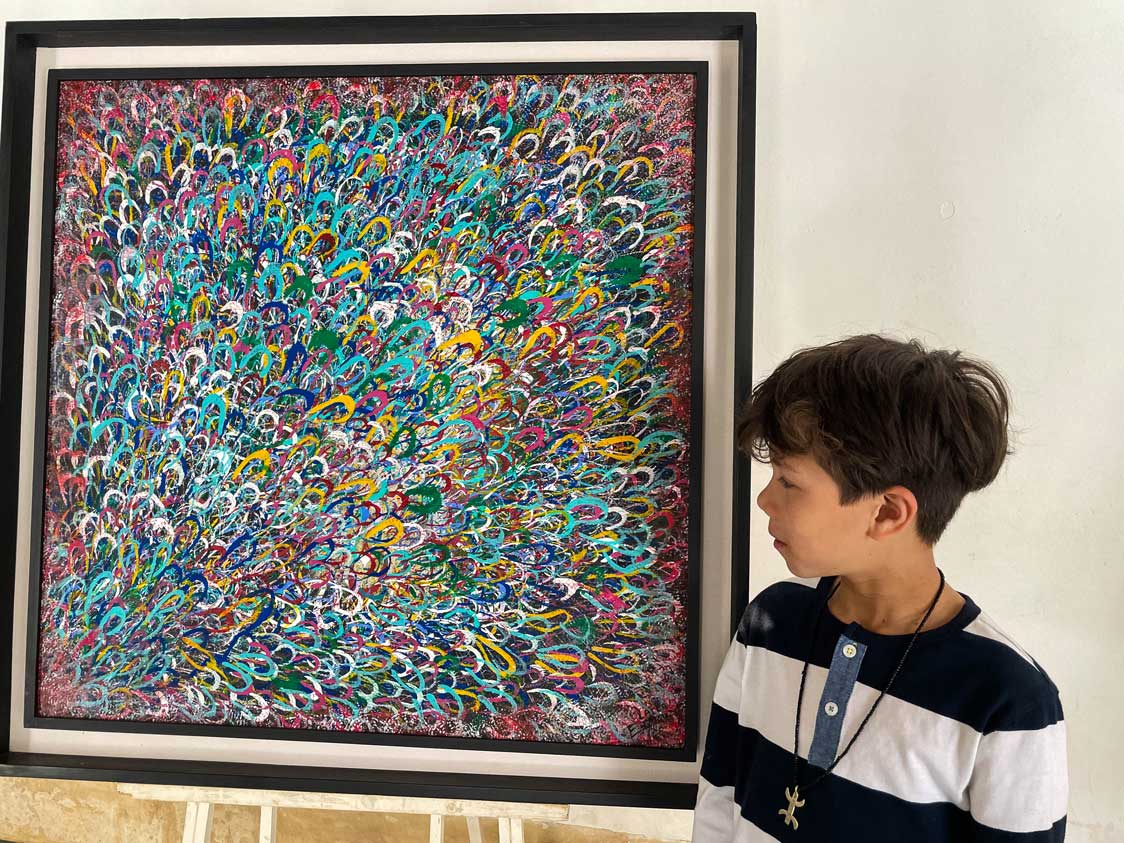 A boy looking at art at Bahia Palace in Marrakech, Morocco