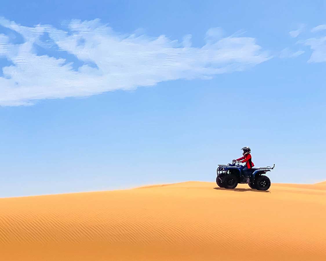 boy quad-biking in the Sahara Desert in Merzouga, Morocco