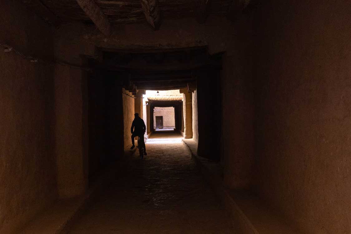 A local rides a bike through underground streets at the Tinejdad ksour in Morocco