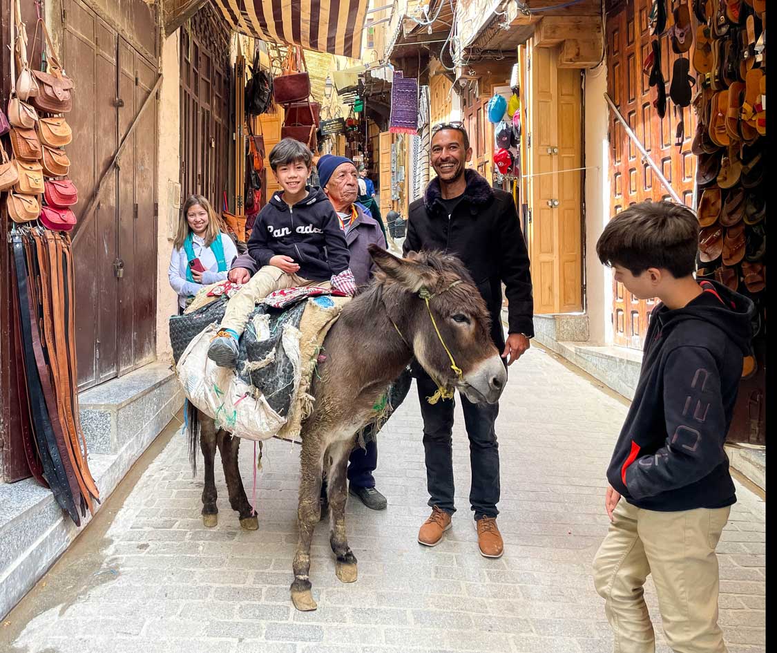 Riding donkeys in the Fes Medina in Morocco with children