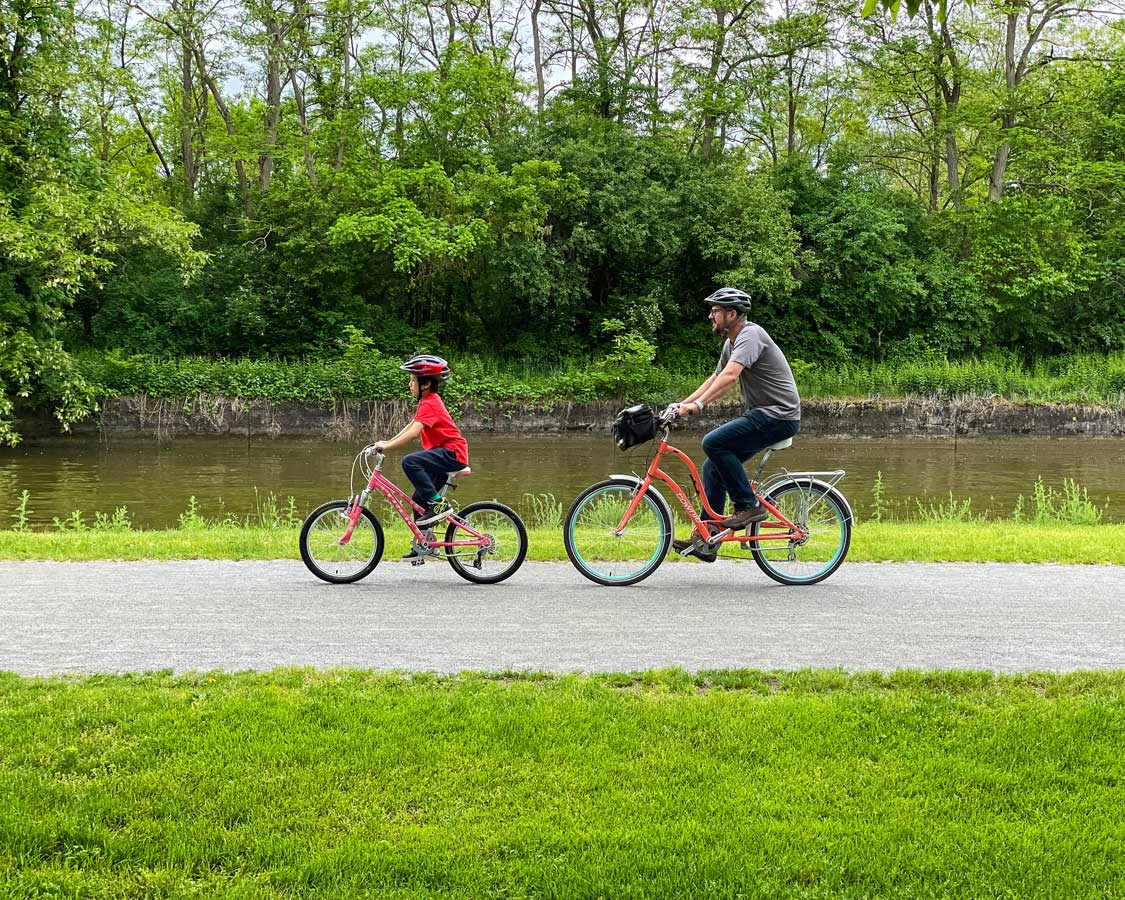 Father and son biking along the Erie Canal in Rochester things to do