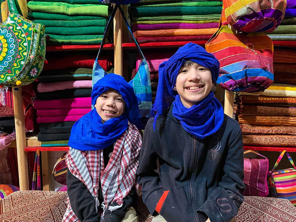 Kids trying on scarves in Fes Morocco