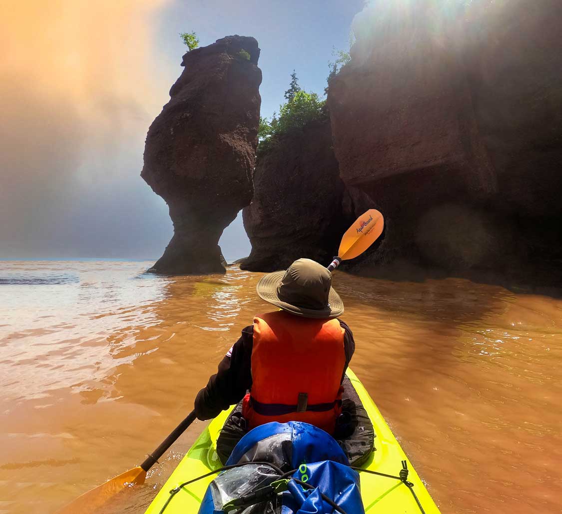 Boy kayaking at Hopwell Rocks Provincial Park in New Brunswick