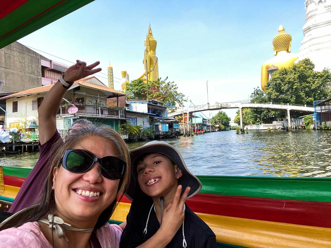 Mother and son on a longtail boat tour in Bangkok, Thailand