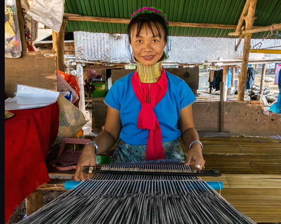 Woman from the long neck Karen hill tribe weaving