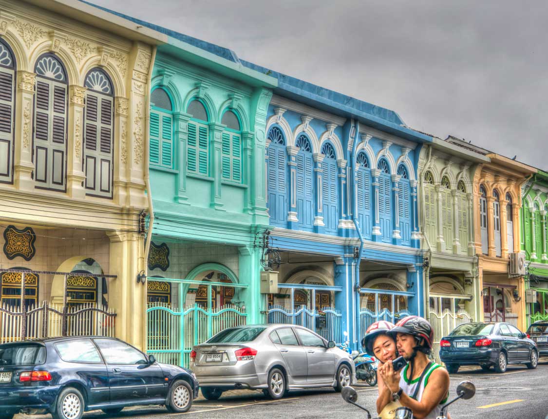 A couple ride a scooter in Phuket old town