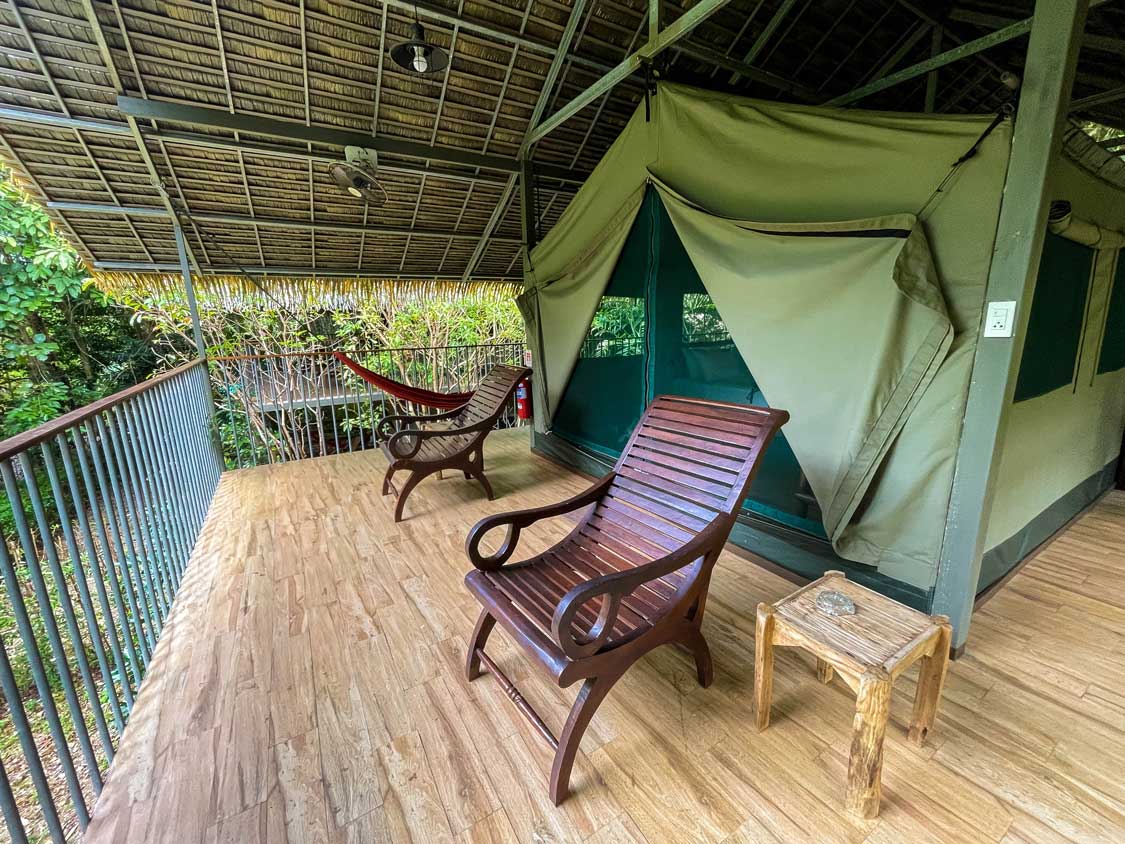 Chairs on a deck outside an Elephant Hills glamping Tent in Thailand