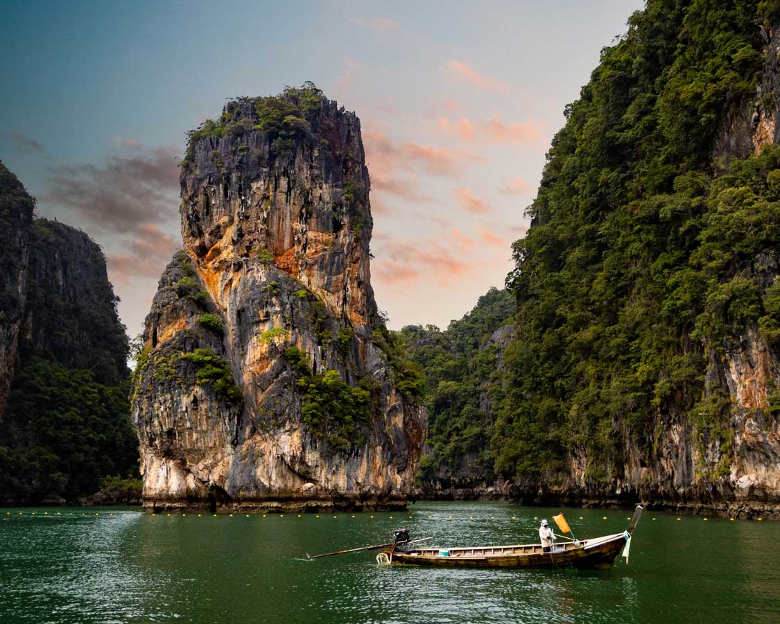 sunset over a tall mountain island called James Bond Island near Phuket