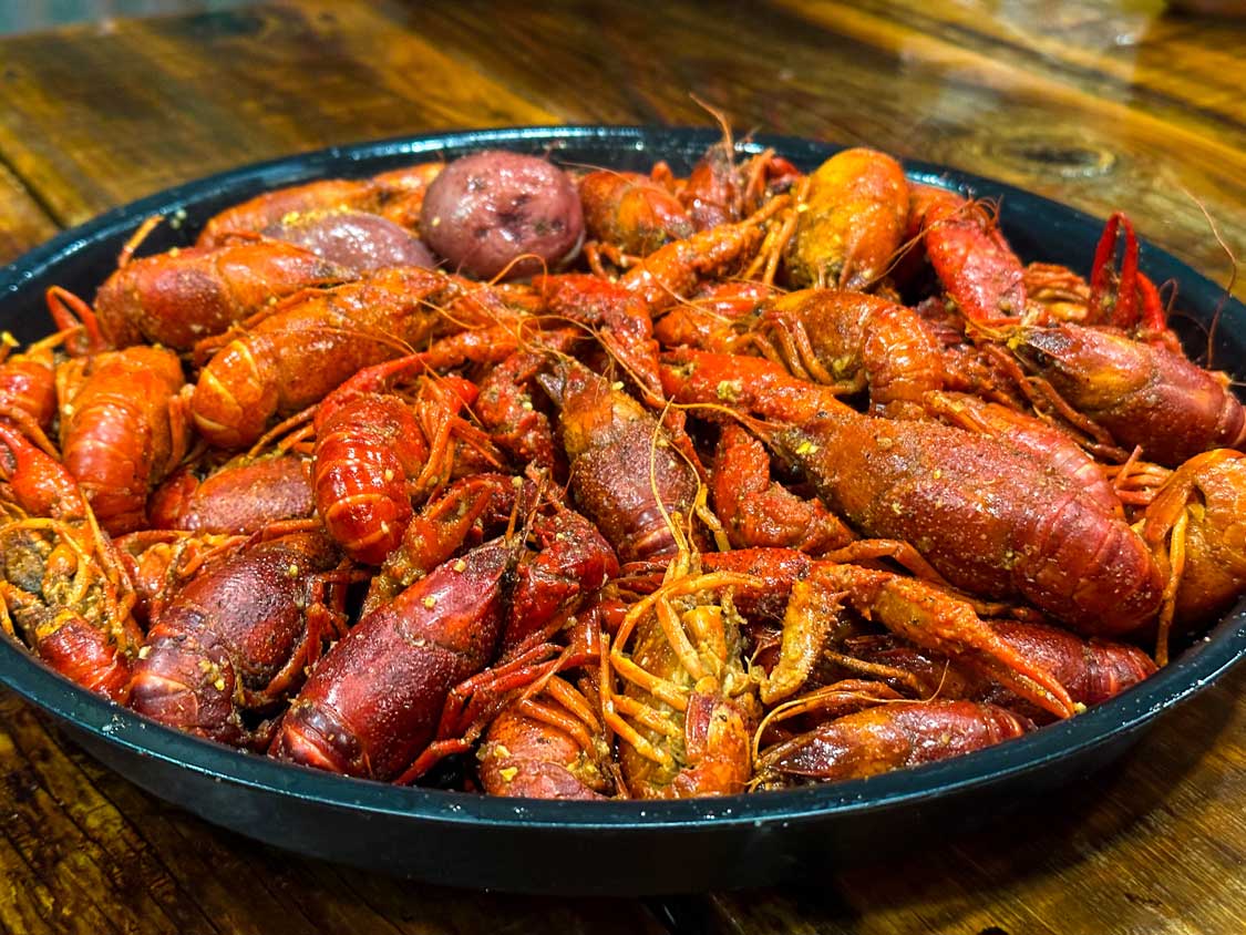 A steaming plate of seasoned crawfish at Cajun Table in Lafayette, Louisiana