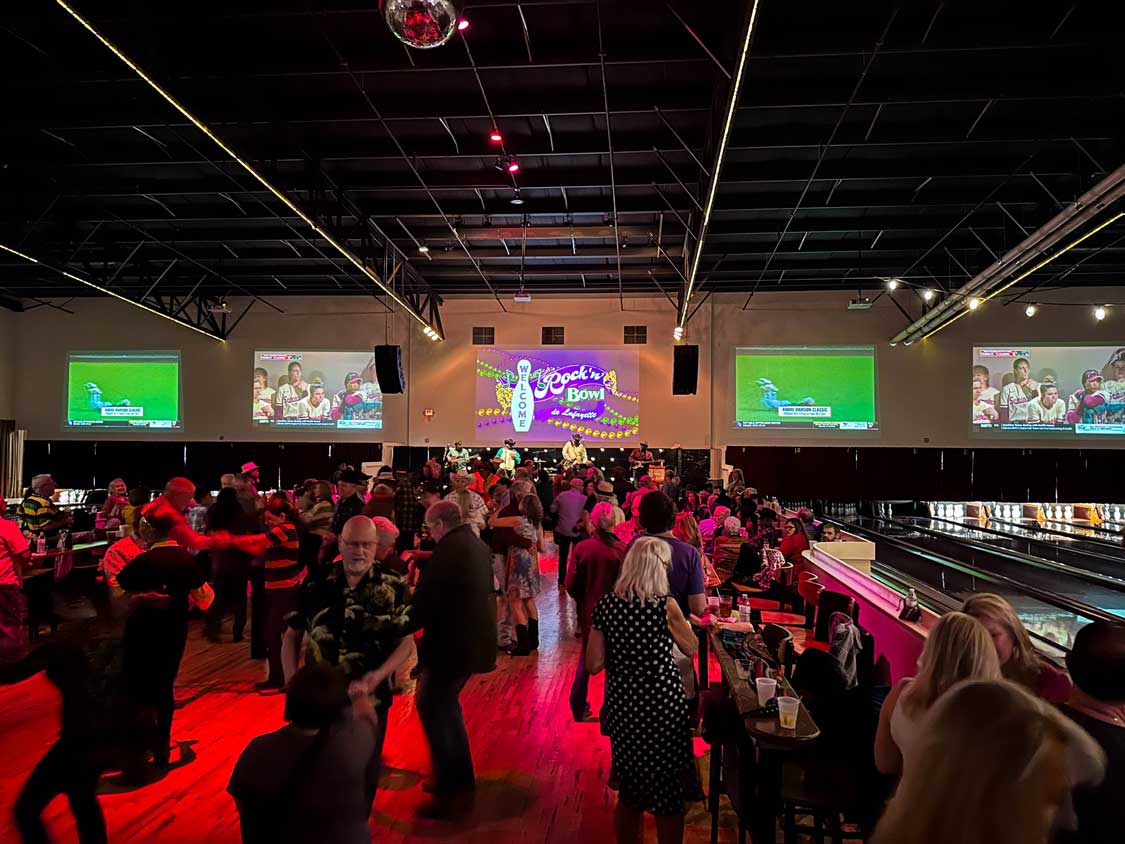 Crowds dance to live music at a bowling alley in Lafayette