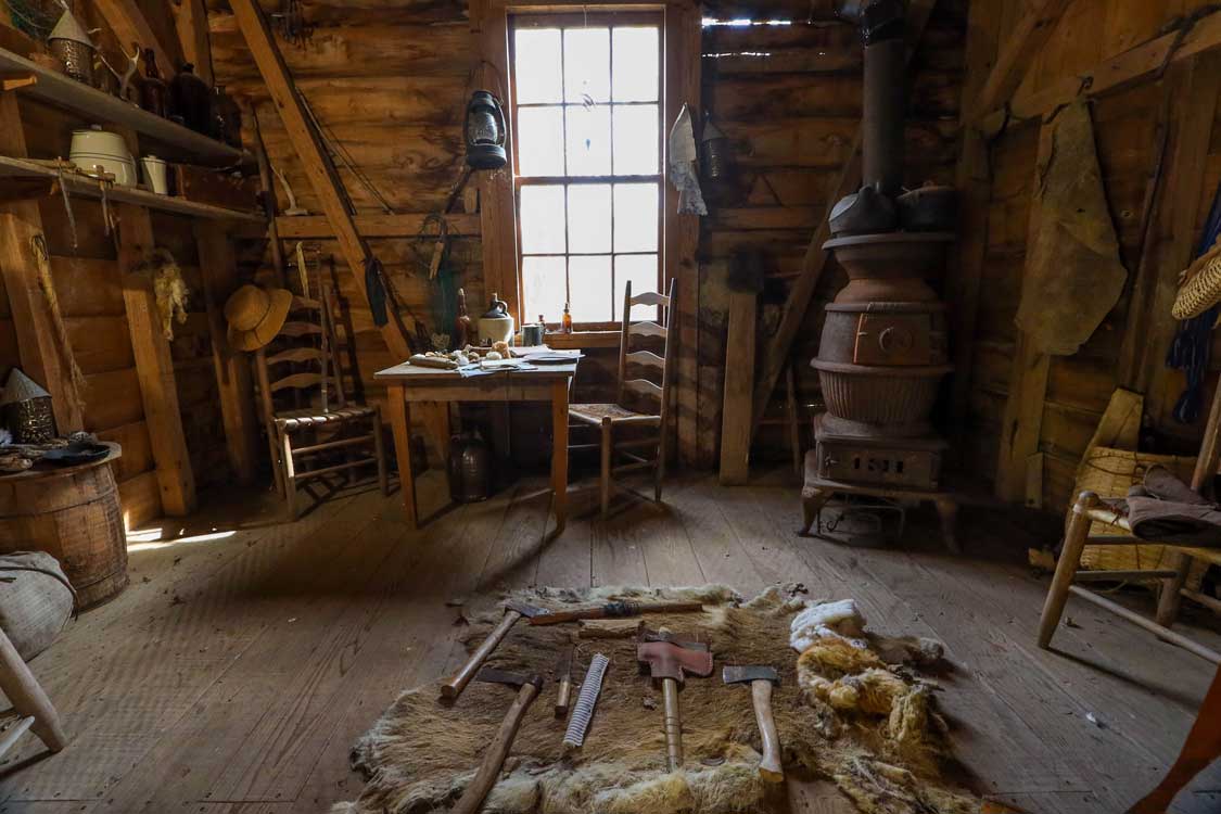 Antique tools and furniture inside a pioneer home at Vermillionville Heritage Center in Lafayette, Louisiana