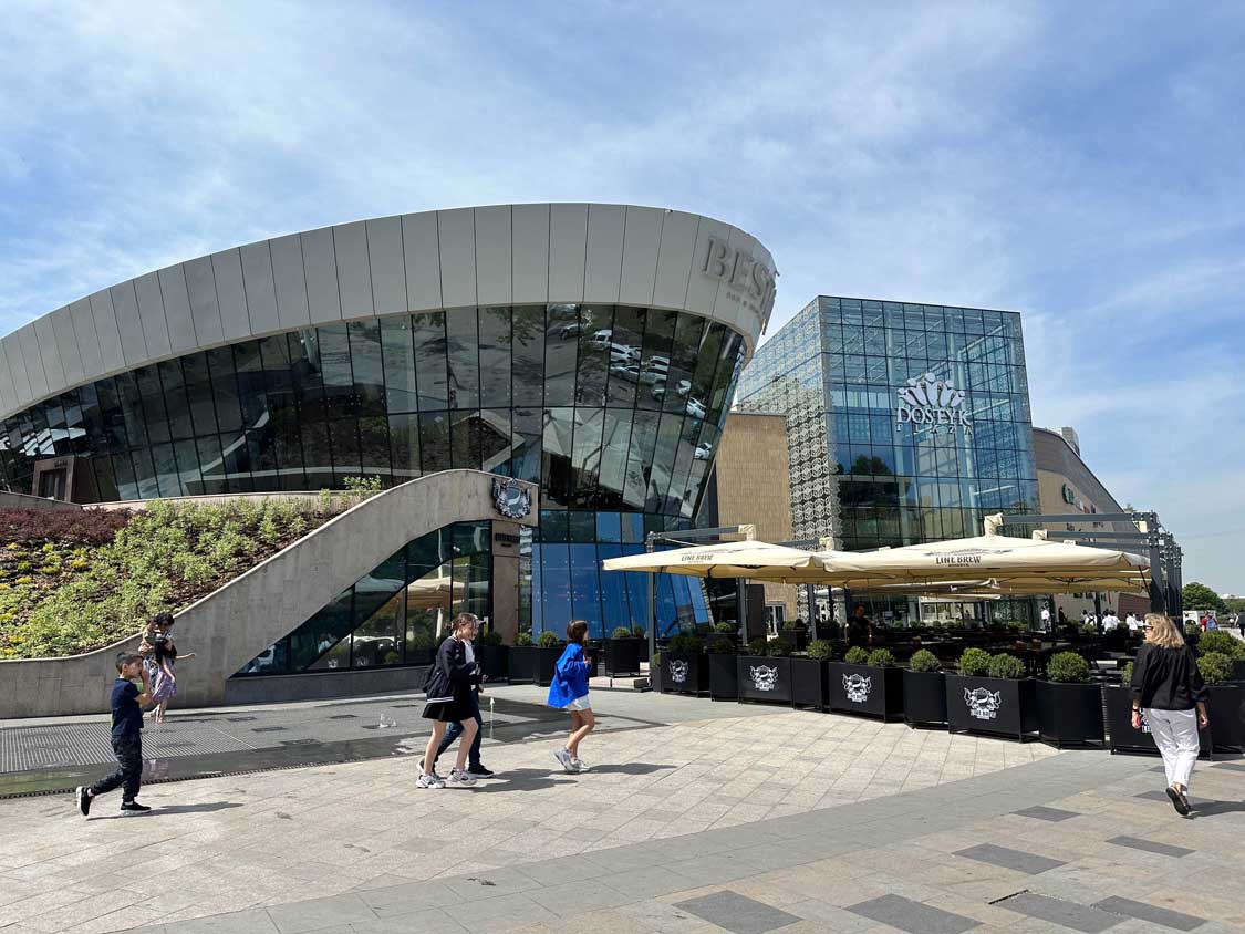 Locals walk around outside of Dostyk Mall in central Almaty