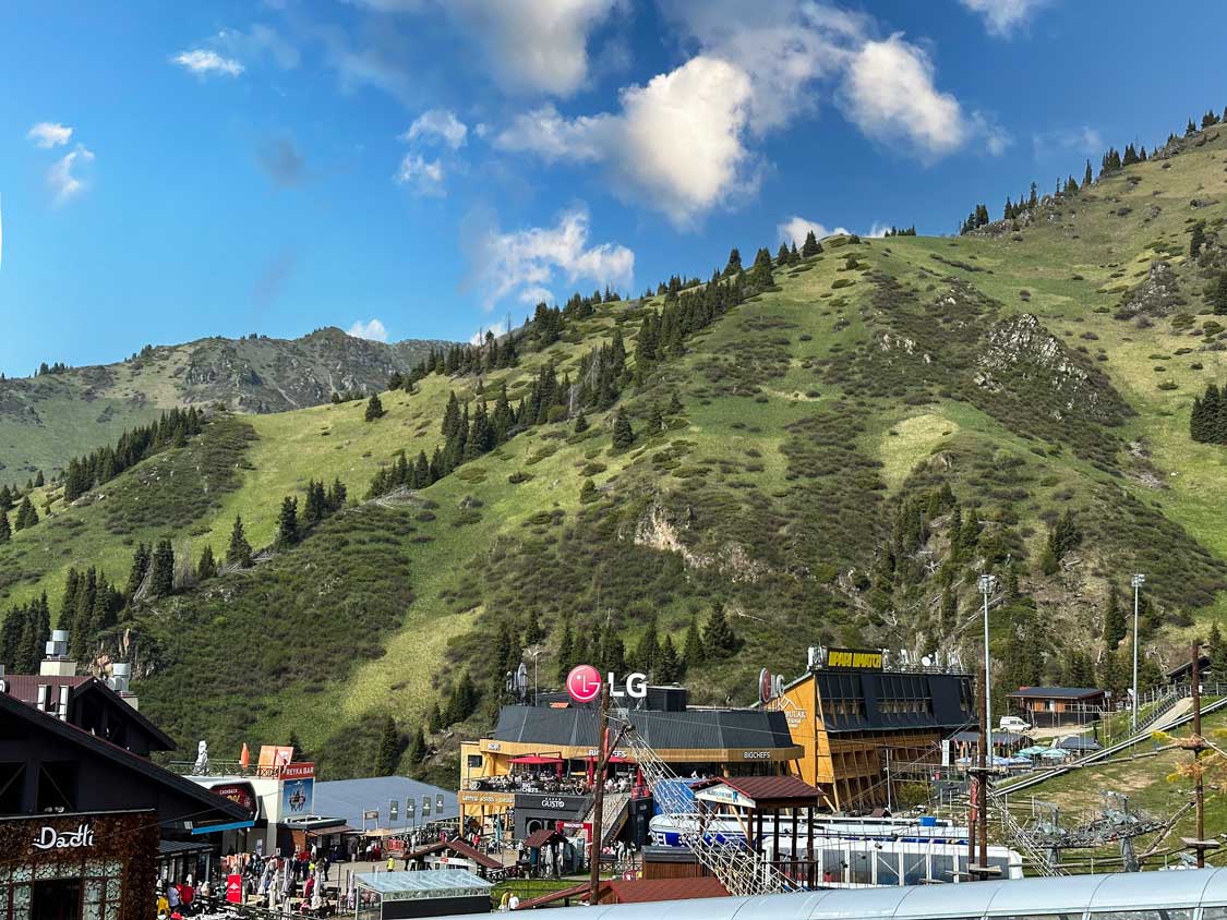 The ski village at Shymbulak ski resort near Almaty during the summer under blue skies