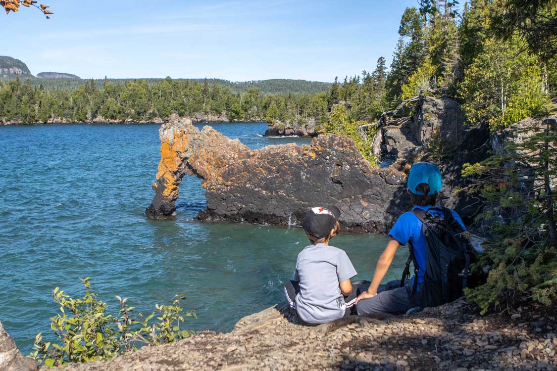 Two boys look at the Sea Lion rock arch in Sleeping Giant Thunder Bay