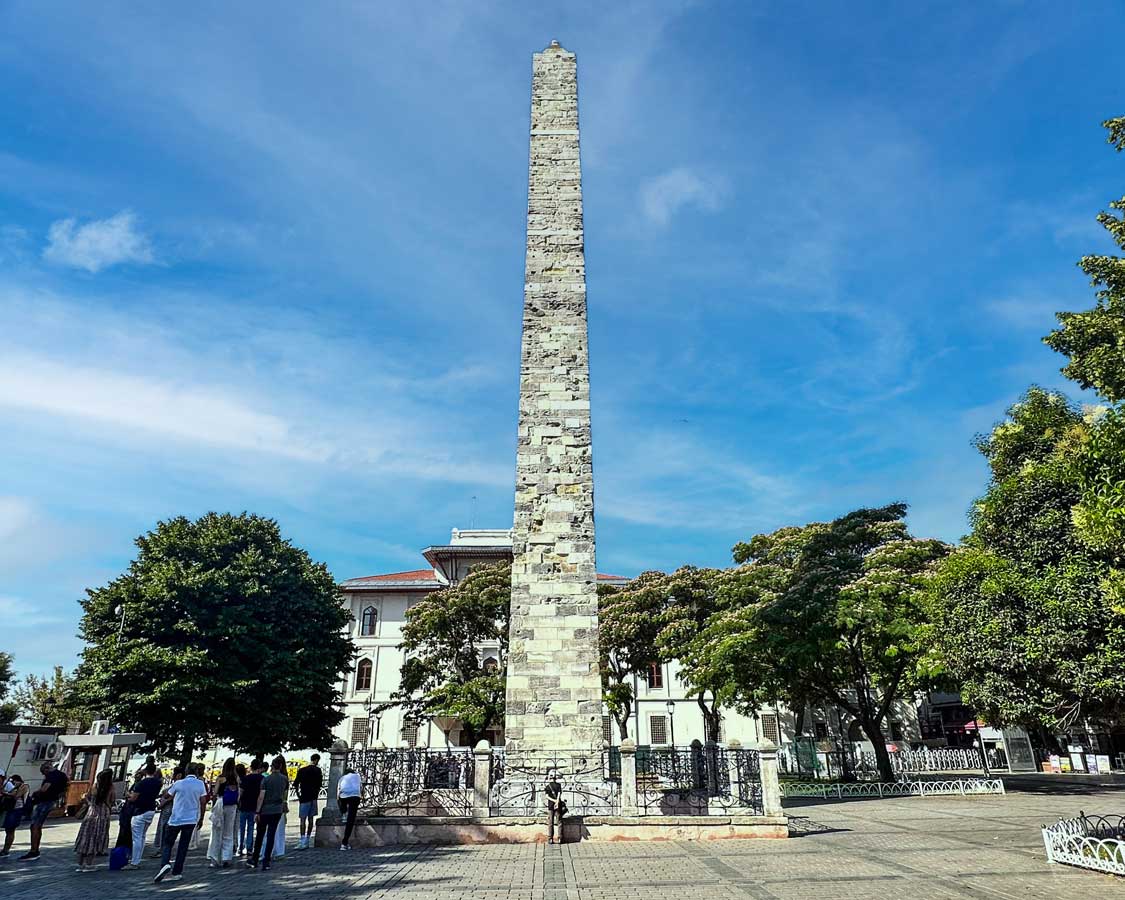 A boy stares up at an obelisk in the Hippodrome of Constantinople in Istanbul