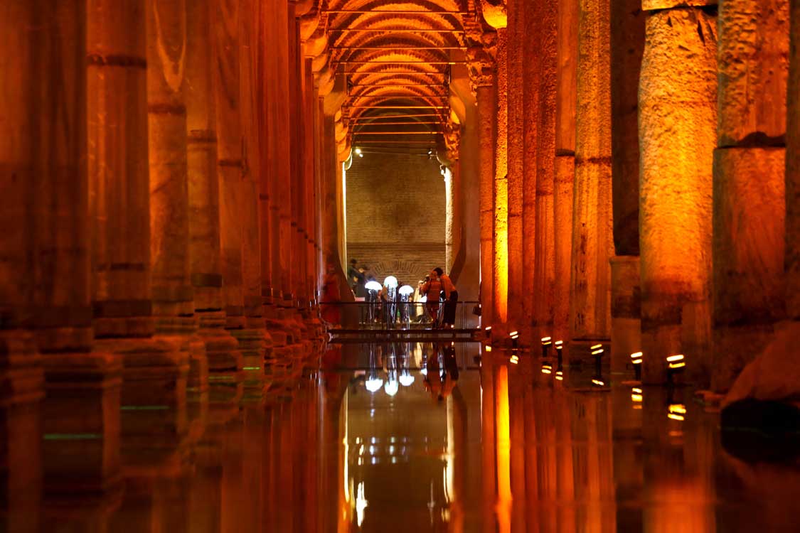 A water-filled cavern with towering arches and pillars in the Basilica Cistern, one of the top things to see in Turkiye