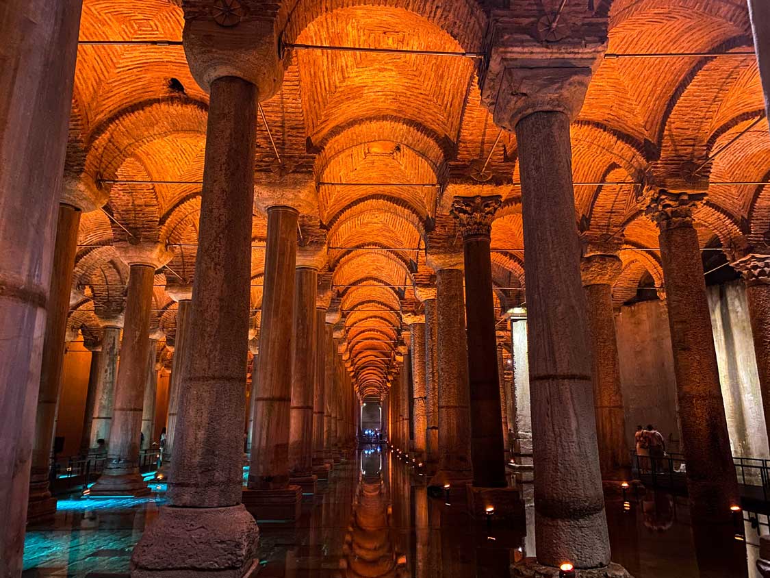 A towering undergound cistern with columns and water