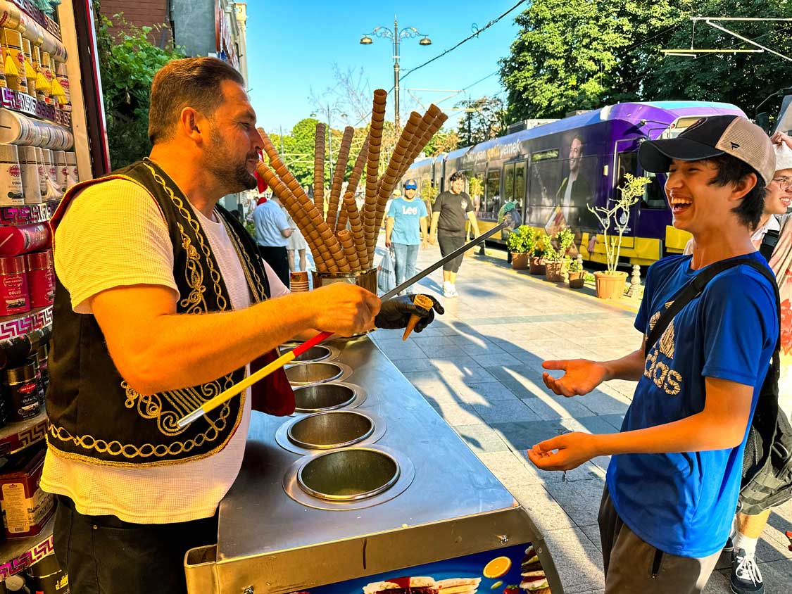 A young boy laughs at a dondurma Turkish ice cream show