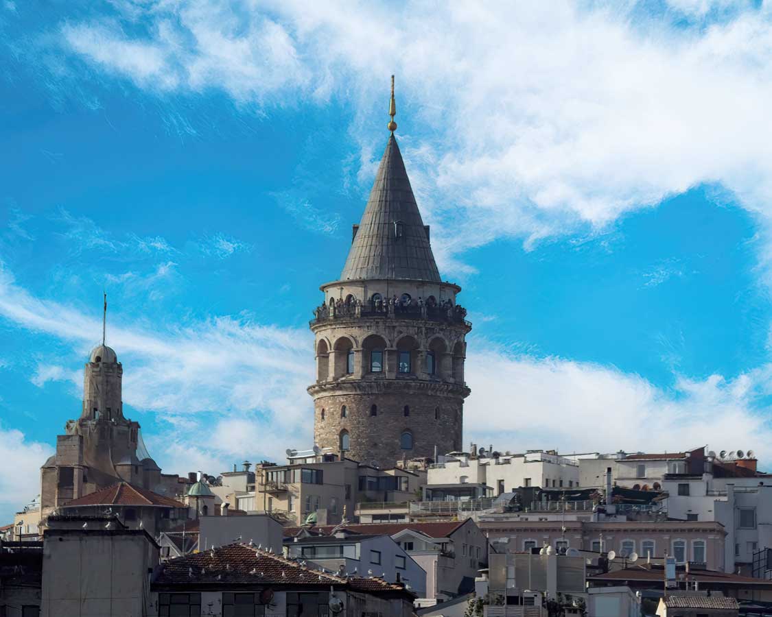A tall stone Galata Tower stands above the skyline in Istanbul