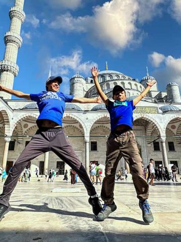 Two boys jumping for joy as they explore the best places to visit in Turkiye for families