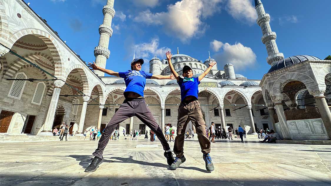 Two boys jumping for joy as they explore the best places to visit in Turkiye for families