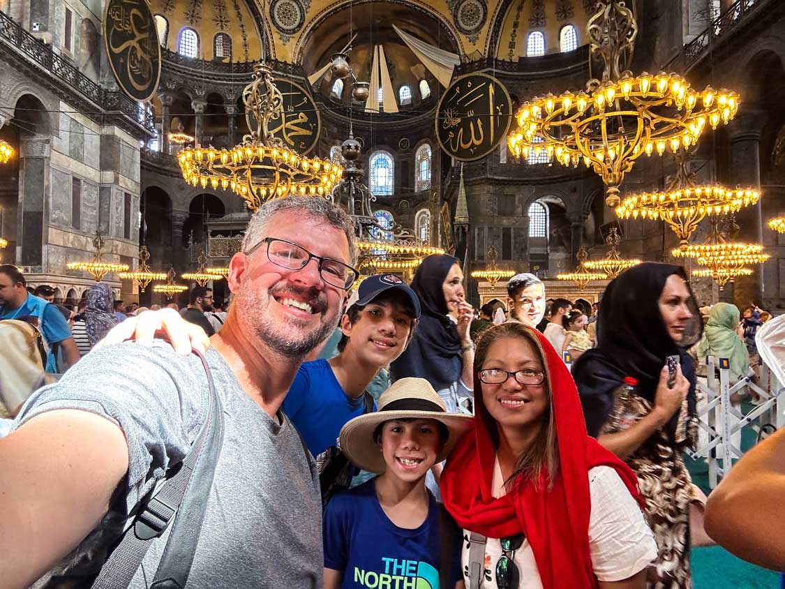A family smiling for a selfie at Hagia Sophia in Istanbul