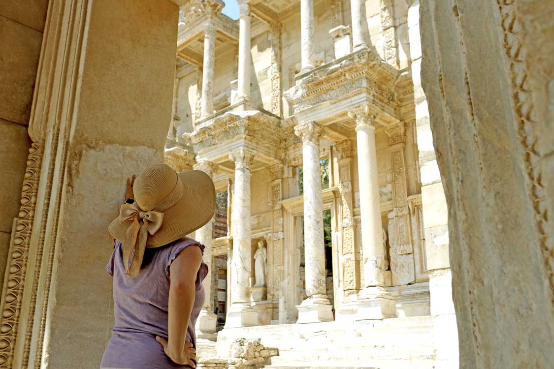 Woman looking up at the library of Ephesus, one of the best places to see in Turkiye