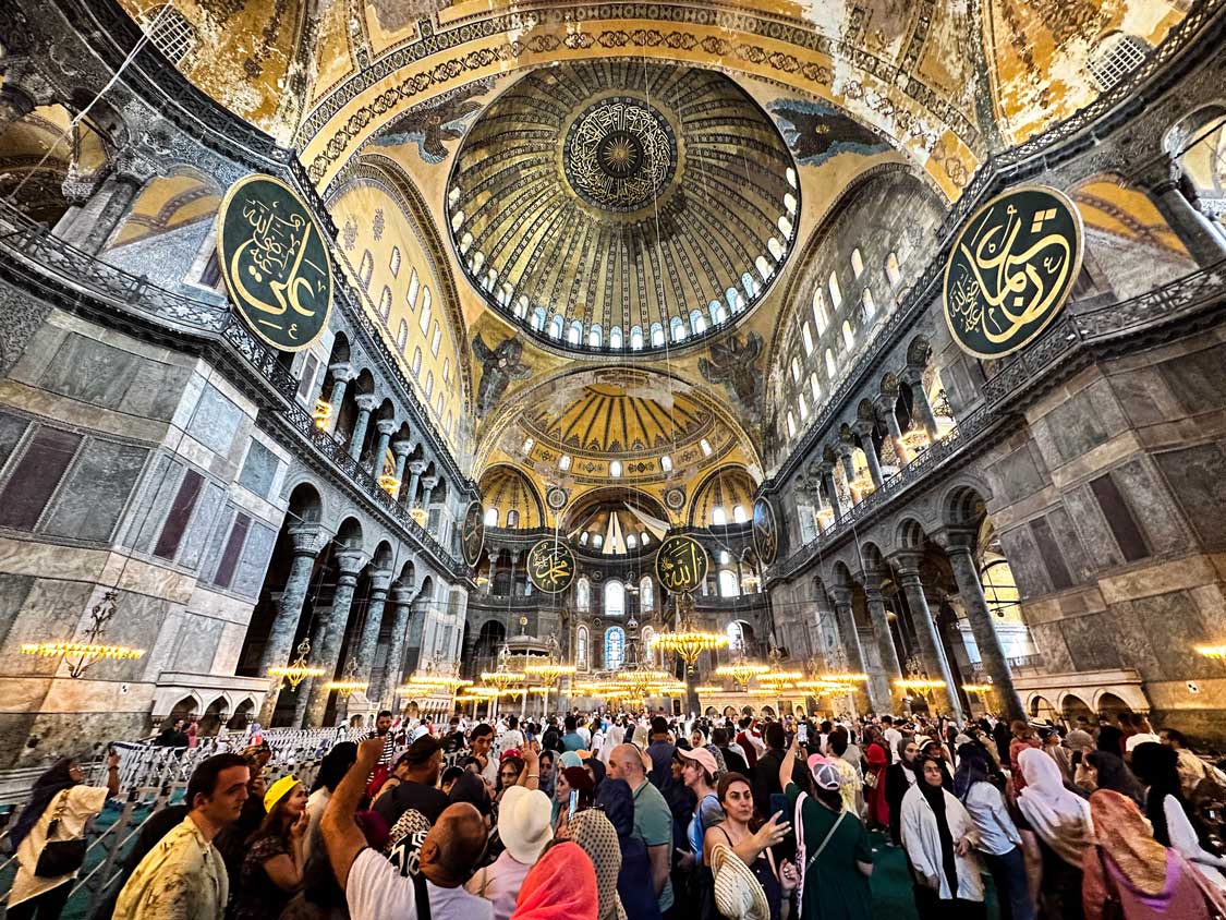 Crowds wander through the cavernous Hagia Sophia