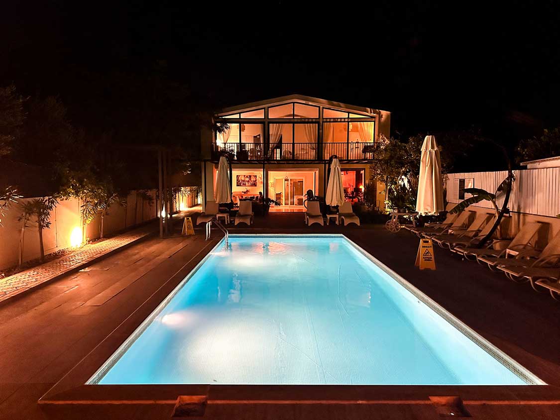 A small hotel at night lit by a large pool at the Arp Dalyan Hotel