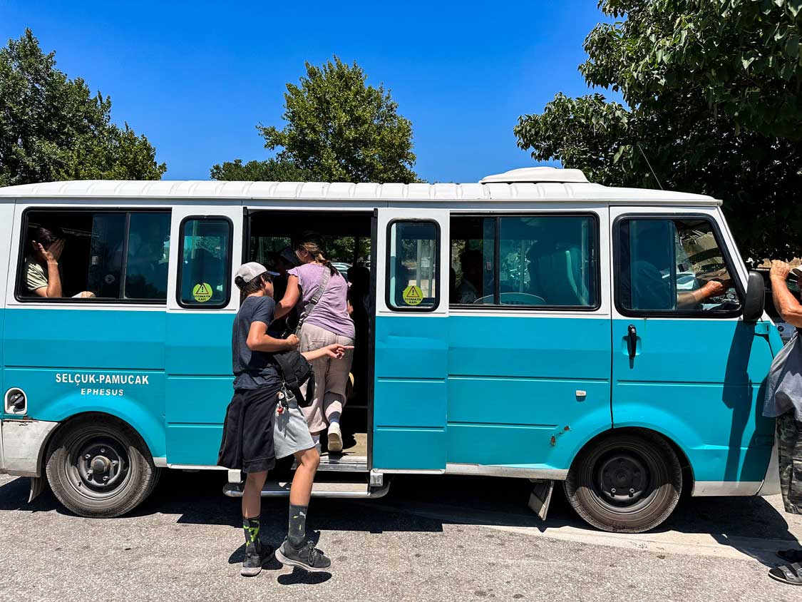 A family boards a minibus between Selcuk and Ephesus