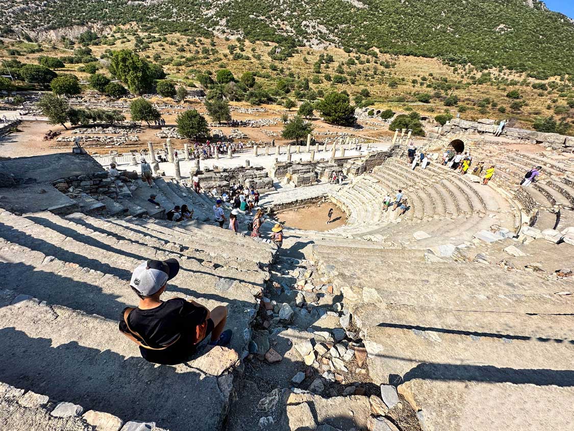 A young boy sits at the top of the Odeion Theater in Ephesus, Turkiye