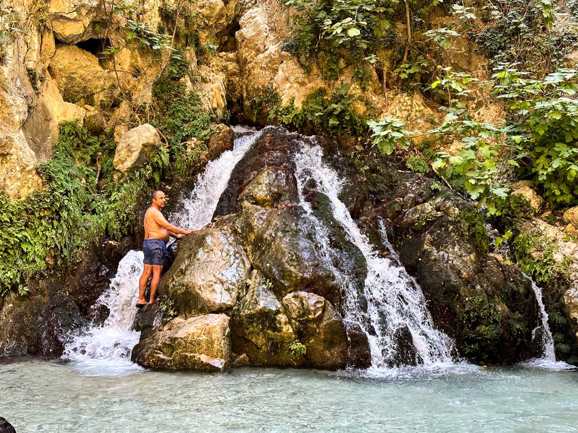 Bronze statue of a fisherman in the man made waterfall, Marmaris