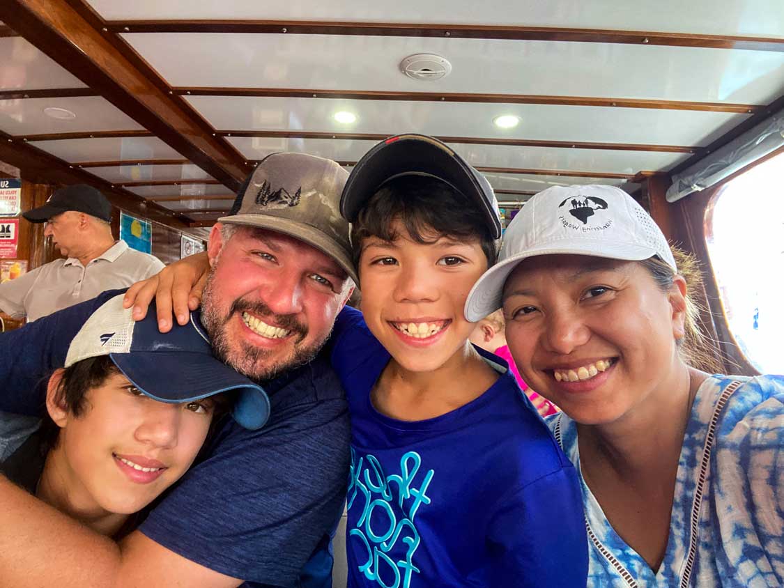 A mixed race family smiles for a selfie while traveling in Fethiye Turkiye