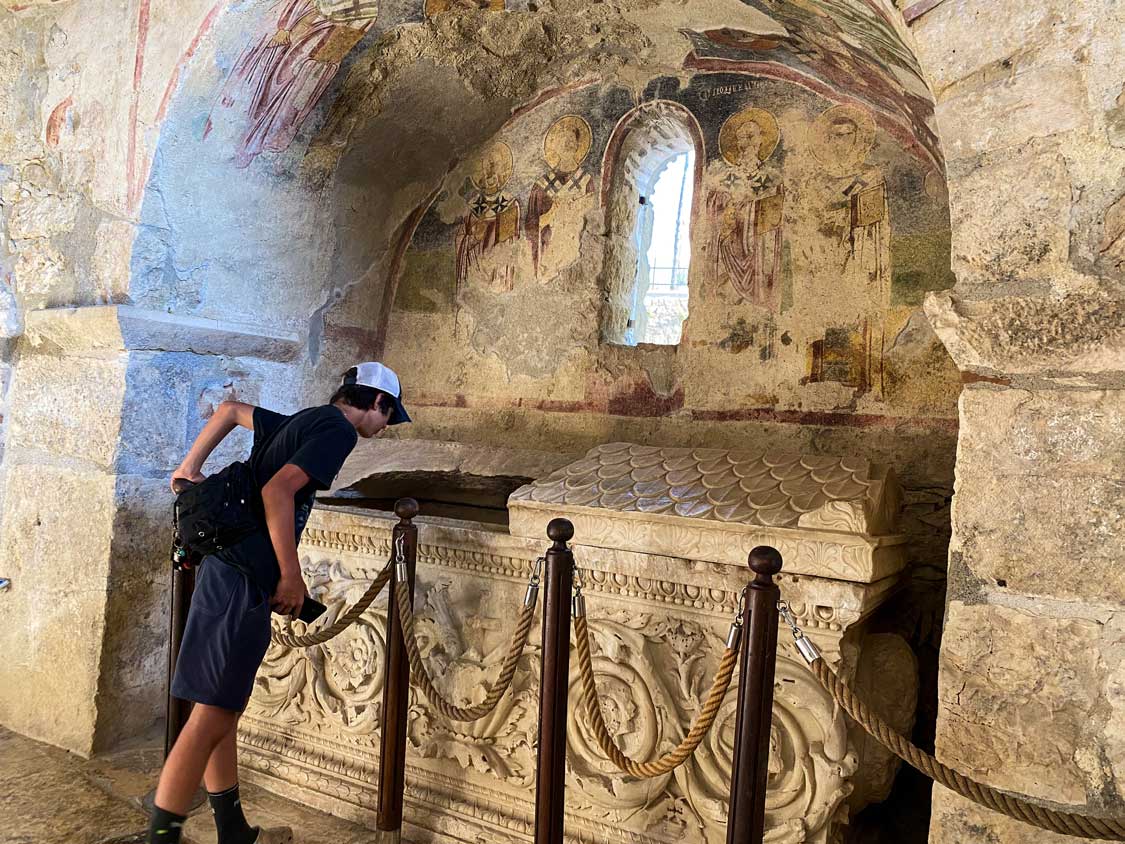 Cohen Wagar peers in a tomb in Saint Nicholas Church in Demre