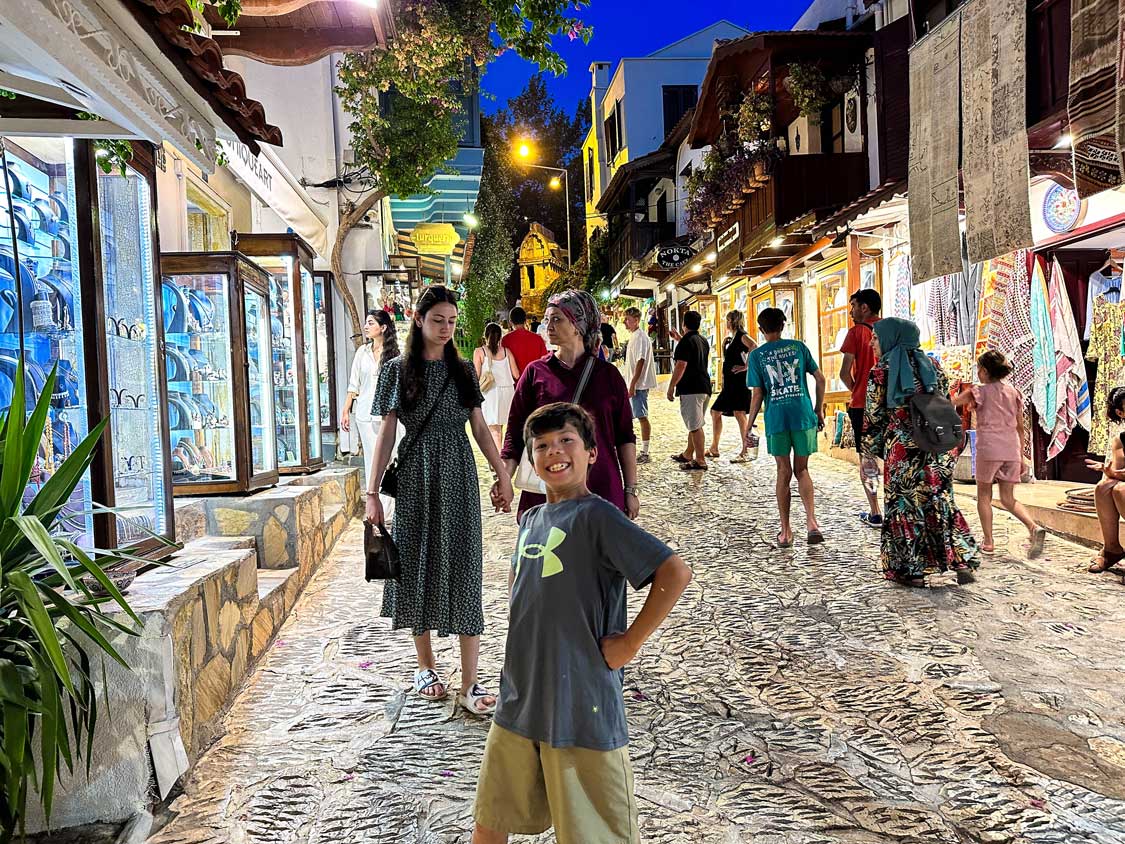 A young boy poses dramatically for the camera while strolling the streets of Kas, Turkiye