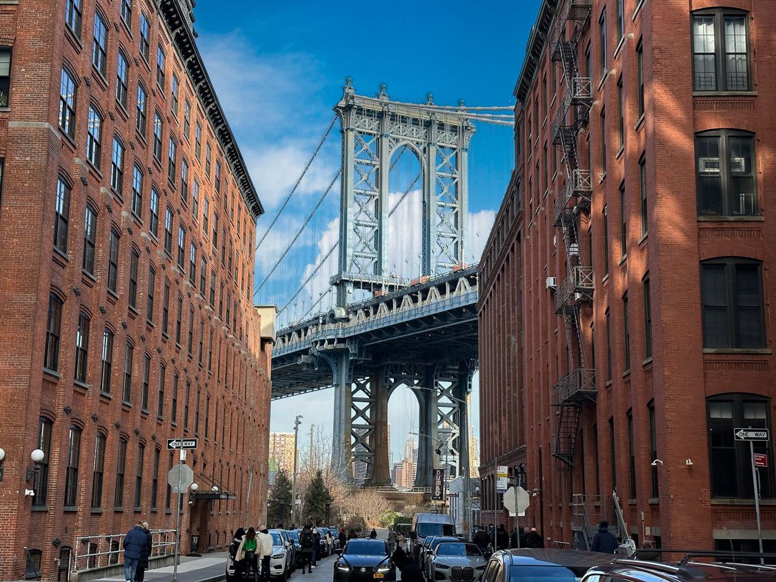 The Brooklyn Bridge seen through buildings from Brooklyn, New York