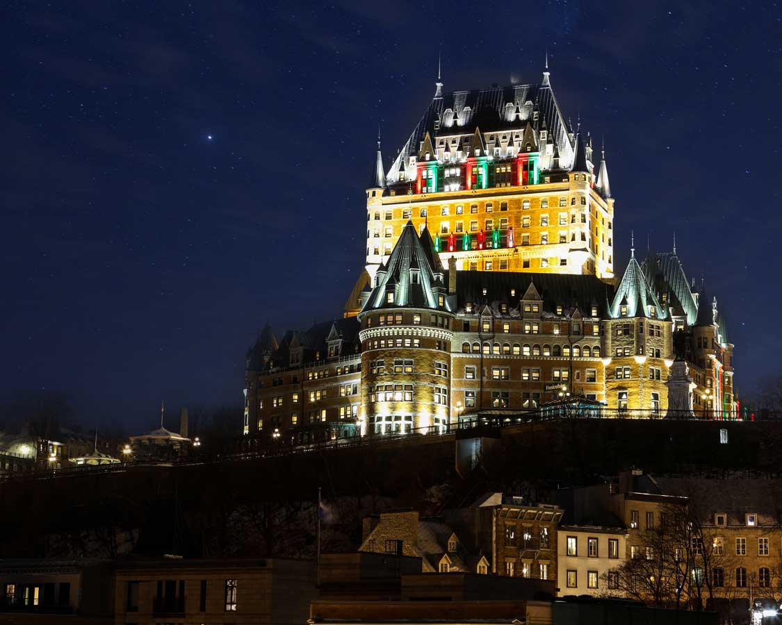 Fairmont Chateau Frontenac hotel in Quebec City against a starry sky